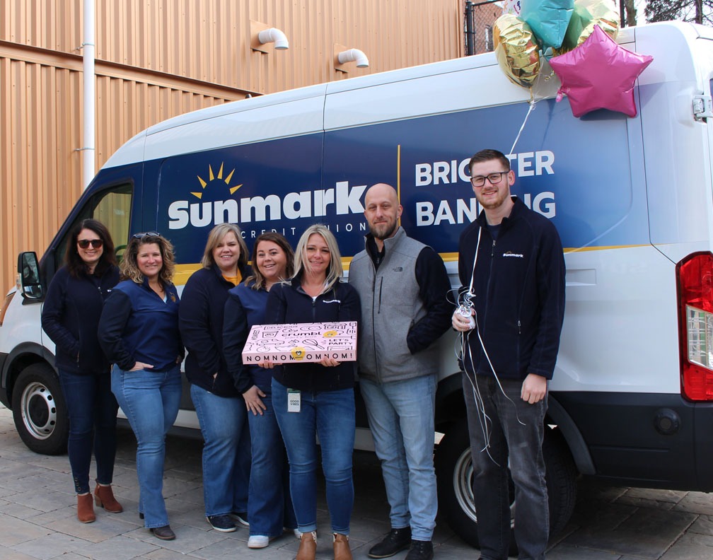 The kindness crew posing in front of a van