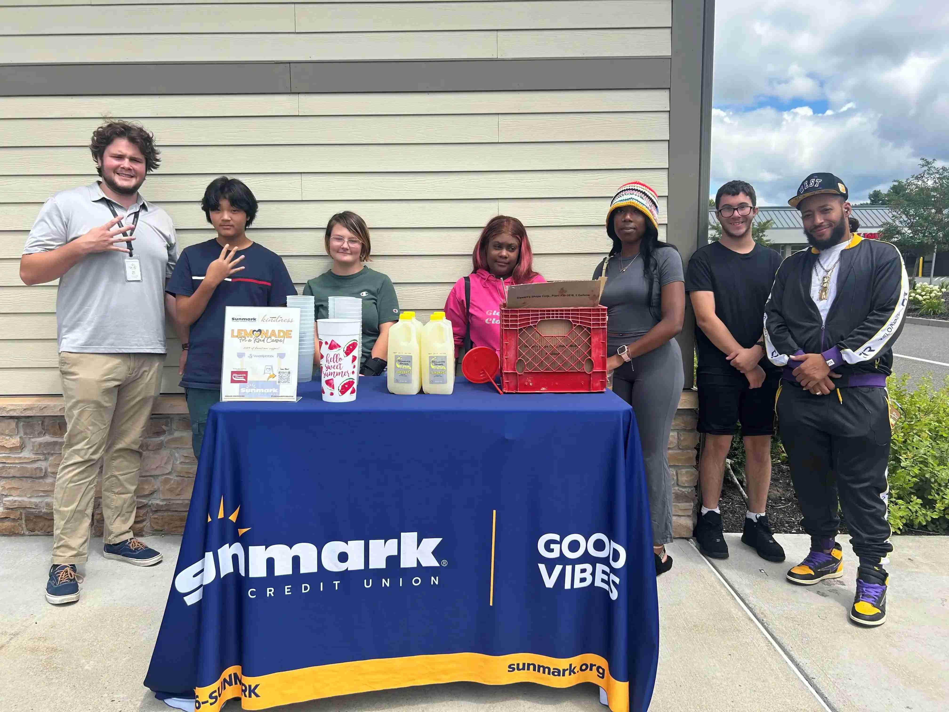 Volunteers standing behind a Sunmark booth